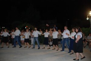 Χορευτές σε σειρά χορεύουν στο πανηγύρι Αγίου Παναγή Μπασιά, Κρύα Ιτεών 2016