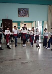 Παιδιά σε παραδοσιακό κύκλο χορού στην αίθουσα του χορευτικού, 2023
