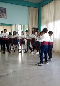 Παιδιά σε παραδοσιακό κύκλο χορού στην αίθουσα του χορευτικού, 2023