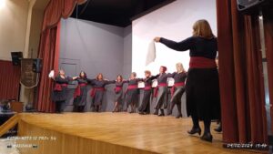 Χορευτές του Λαϊκού Εργαστηρίου Πάτρας σε παραδοσιακό χορό στη σκηνή, 2024