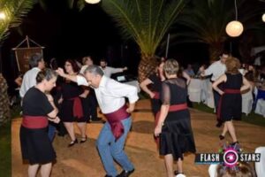 Χορευτές σε κίνηση χορού με φώτα και φοίνικες στο βάθος, 2017